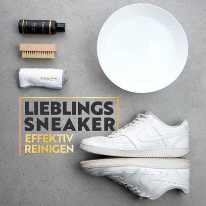 Canzt Sneaker Cleaner mit Bürste, Schale und Mikrofasertuch neben einem weißen Sneaker